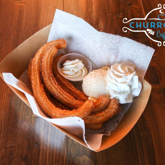 Churro Hub Cafe churros with ice cream and whipped cream.