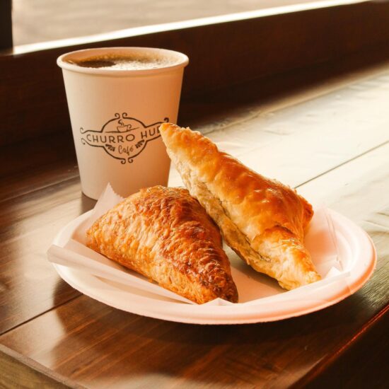 Two pastries and coffee on a table.