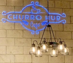 Churro Hub logo with blue color on the wall