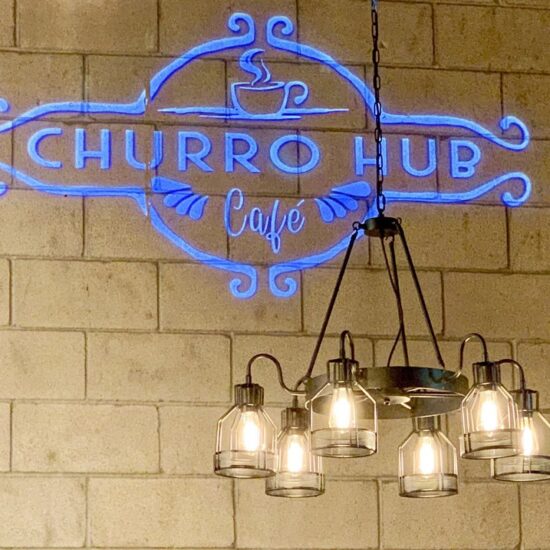 Churro Hub logo with blue color on the wall